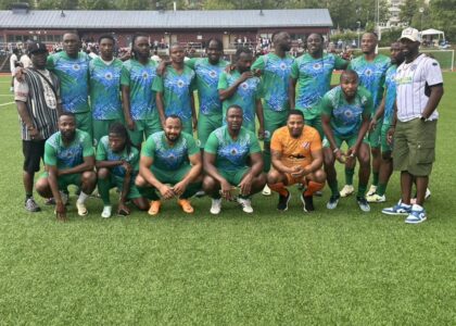 ORSLIS football team standing to atke a club photo.